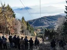 The fire brigade helicopter lifts the cabin of the Mottarone cable car that crashed in May in Stresa, 08 November 2021. The elicopter take it to the sports field of Gignese, where it will then be transferred by truck to the province shed at the Tecnoparco di Verbania-Fondotoce. ANSA/TINO ROMANO