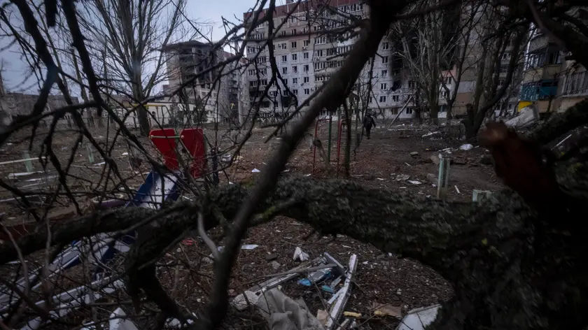 epa10492630 A view of a playground and destroyed buildings taken through the branches of a tree in Vuhledar, eastern Ukraine, 26 February 2023. The heavily destructed and embettled town is under constant Russian artillery bombardment. Vuhledar is only linked by a mud road that is within reach of Russian positions. Russian troops entered Ukrainian territory on 24 February 2022, starting a conflict that has provoked destruction and a humanitarian crisis. EPA/RICARDO GARCIA VILANOVA