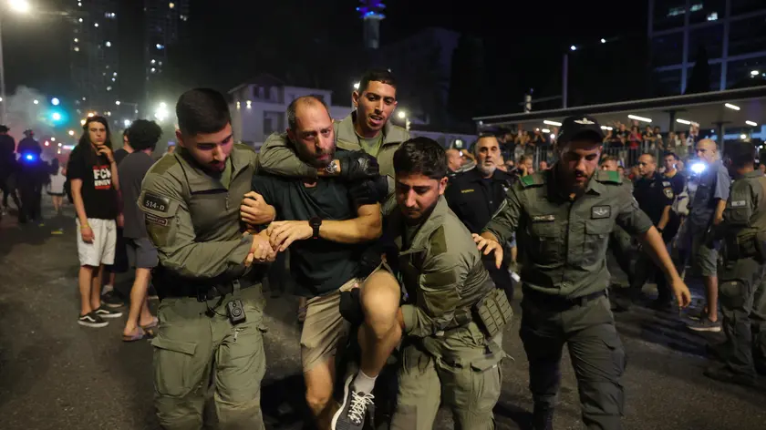 epa11413897 Police arrest protesters that blocking a roads calling on the Israeli war cabinet to sign a hostage deal during a rally outside the Kirya military headquarters in Tel Aviv, Israel, 15 June 2024. According to the Israeli defense forces, around 120 Israelis hostages are still held by Hamas in Gaza. More than 37,000 Palestinians and over 1,400 Israelis have been killed, according to the Palestinian Health Ministry and the Israel Defense Forces (IDF), since Hamas militants launched an attack against Israel from the Gaza Strip on 07 October 2023, and the Israeli operations in Gaza and the West Bank which followed it. EPA/ABIR SULTAN