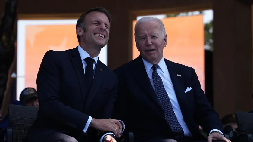 epa11393147 President Joe Biden and French President Emmanuel Macron laugh during a commemorative ceremony to mark D-Day 80th anniversary, Thursday, June 6, 2024 at the US cemetery in Colleville-sur-Mer, Normandy. Normandy is hosting various events to officially commemorate the 80th anniversary of the D-Day landings that took place on June 6, 1944. EPA/Daniel Cole / POOL MAXPPP OUT