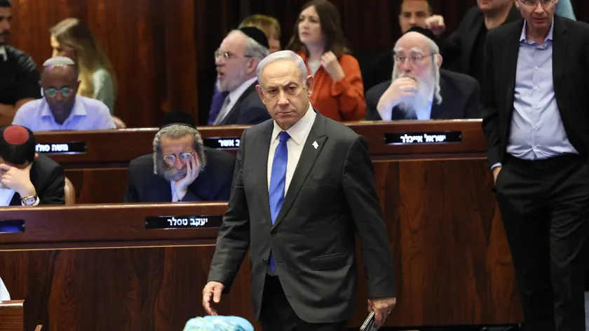 epa11403058 Israeli Prime Minister Benjamin Netanyahu (C) attends the Knesset plenum vote on the ultra-Orthodox conscription to military service law, in the Knesset, Israeli parliament in Jerusalem, 10 June 2024. The Knesset vote on the controversial exemption for ultra-Orthodox Yeshiva students from military conscription. Israel’s Supreme Court heard on 02 June a response by the state over the ultra-Orthodox recruitment issue, after previously extending a deadline for the government to present a conscription plan for ultra-Orthodox Jews, who are traditionally exempt from military service. EPA/ABIR SULTAN
