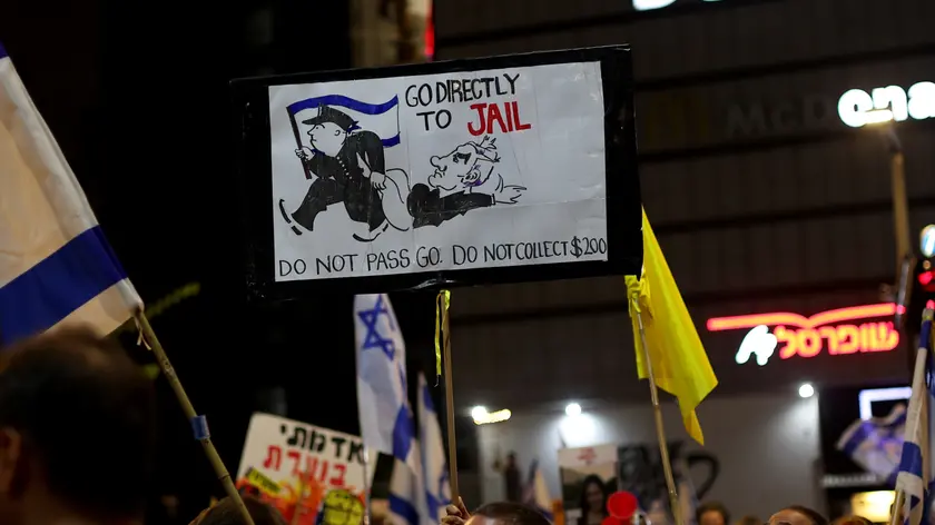 epa11576374 A demonstrator holds up a banner depicting a caricature of Israeli Prime Minister Benjamin Netanyahu takes part in a protest calling for the immediate release of the Israeli hostages held by Hamas in Gaza, next to the Kirya in Tel Aviv, Israel, 31 August 2024. According to the Israeli Defence Forces (IDF), 107 Israeli hostages remain in captivity in the Gaza Strip. Rallies in Israel have been critical of the Israeli government's handling of the crisis, demanding the immediate release of all hostages. EPA/ATEF SAFADI