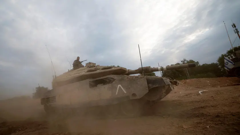 epa10948894 An Israeli military unit with a tank during maneuvers in the Western Galilee, as they guard along the border with Lebanon, northern Israel, 30 October 2023. Tensions remain high at the border between Israel and Lebanon after the Israeli-Palestinian conflict escalated following an unprecedented attack carried out by Hamas militants from Gaza into Israel on 07 October 2023. EPA/ATEF SAFADI
