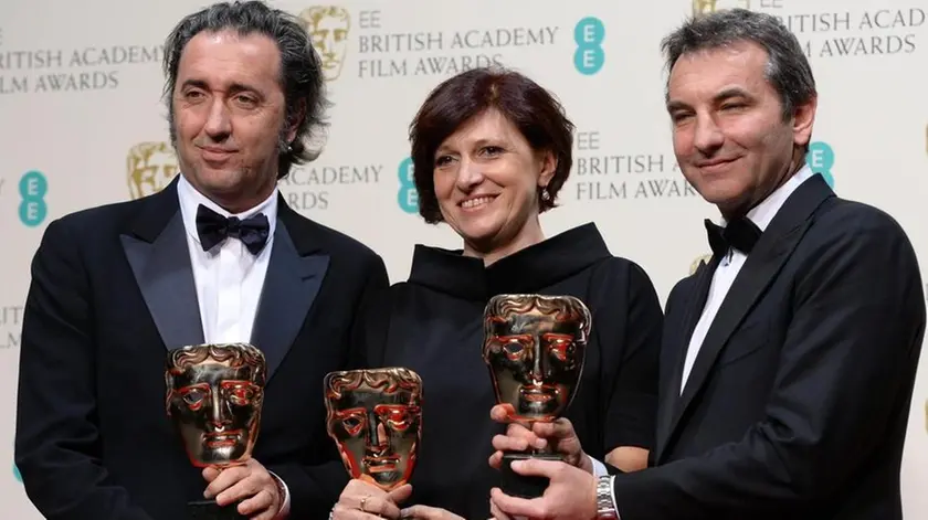 (L-R) Italian director Paolo Sorrentino, and producers Francesca Cima and Nicola Giuliano pose in the press room after winning the Film Not in the English Language in 2014 award for 'La Grande Bellezza (The Great Beauty)' at the 2014 EE British Academy Film Awards ceremony at The Royal Opera House in London, Britain, 16 February 2014. The ceremony was hosted by the British Academy of Film and Television Arts (BAFTA). ANSA /ANDY RAIN