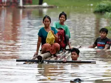 epa11603212 Flood victims wade through the flood waters with a makeshift raft during the flood in Taungoo, Bago division, Myanmar, 14 September 2024. Heavy rains triggered by Typhoon Yagi have caused severe flooding in parts of Myanmar, leaving thousands stranded in their homes, with further heavy rainfall and thunderstorms expected, according to the state weather office. A statement from the Military announced 59,413 households were affected in 34 townships and set up 187 relief camps for the 236,649 people. There were 33 casualties due to the flood in the country including the Naypyitaw. EPA/NYEIN CHAN NAING