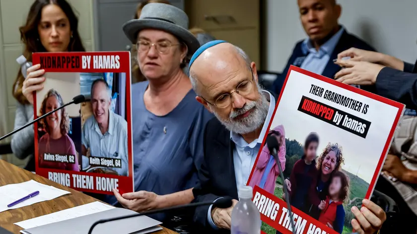 epa10949255 Hostage relatives Sandy Feldman (L) and Ilan Feldman (R) hold posters of their kidnapped relatives as the Georgia-Israel Legislative Caucus holds a 'Bring Them Home' news conference at the Georgia State Capitol in Atlanta, Georgia, USA, 30 October 2023. According to the Israel Defence Forces (IDF), more than 230 people, both Israelis and foreign nationals, were taken hostage by Hamas on 07 October. Thousands of Israelis and Palestinians have died since the militant group Hamas launched an unprecedented attack on Israel from the Gaza Strip on 07 October 2023 and the Israeli strikes on the Palestinian enclave that followed it. EPA/ERIK S. LESSER