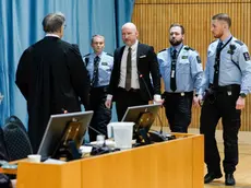 epa11064127 Anders Behring Breivik (C) arrives at the courtroom surrounded by guards before the Oslo district court is set to hear the case concerning his sentencing conditions and his rights under the European Convention, at Ringerike prison near Tyristrand, Norway, 08 January 2024. Breivik, who now calls himself Fjotolf Hansen, was sentenced to 21 years in prison with a minimum term of 10 years for the terrorist attacks against Oslo and Utoya on 22 July 2011 in which 77 people lost their lives. EPA/CORNELIUS POPPE NORWAY OUT