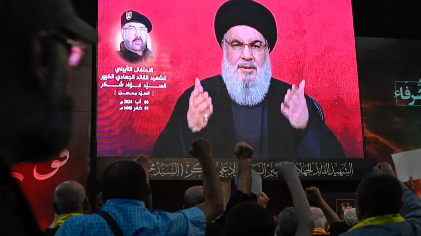 epa11530786 Hezbollah leader Hassan Nasrallah delivers a televised speech at a memorial ceremony to mark one week since the killing of late Hezbollah senior commander Fuad Shukr, in Beirut, Lebanon, 06 August 2024. Shukr was killed in an Israeli strike on 30 July in the Haret Hreik neighborhood of Beirut. EPA/WAEL HAMZEH