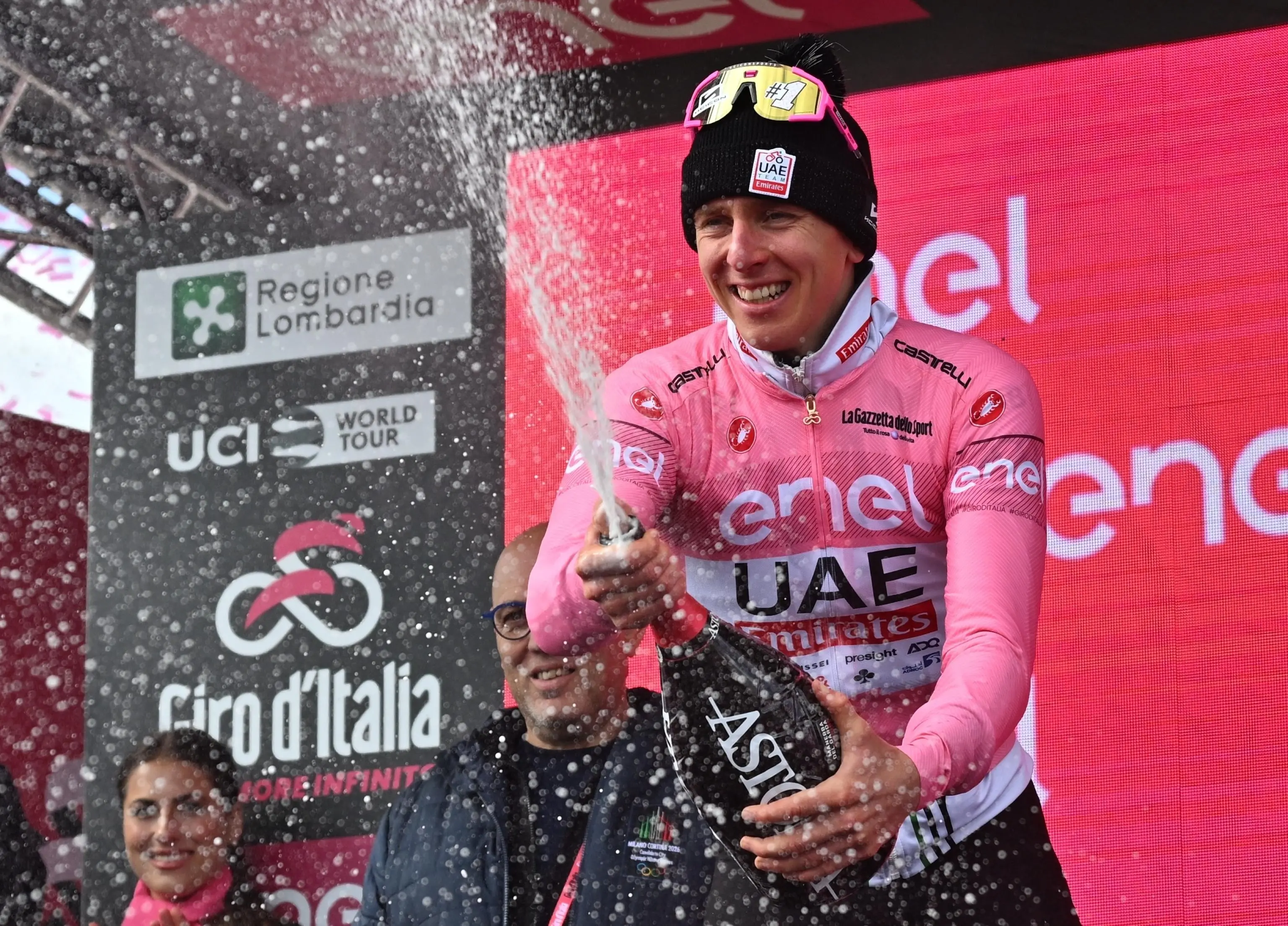 Slovenian rider Tadej Pogacar of Uae Team Emirates retaining the overall leader's pink jersey celebrates on the podium after the 15th stage of the 107 Giro d'Italia 2024, over 222 km from Manerba del Garda to Livigno, Italy, 19 May 2024. ANSA/LUCA ZENNARO