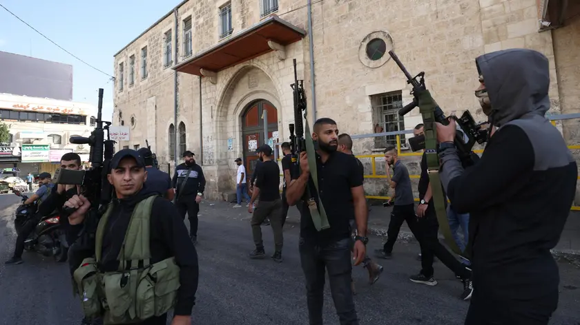 epa10948782 Armed Palestinian militants attend the funeral of four Palestinians killed during Israeli raids in the West Bank city of Jenin, 30 October 2023. According to the Palestinian Health Ministry, at least four Palestinians have been killed and five others injured during Israeli raids in Jenin. Israeli military spokesperson Daniel Hagari announced on 30 October, the Israeli Air Force (IAF) carried out an air strike operation in Jenin. EPA/ALAA BADARNEH