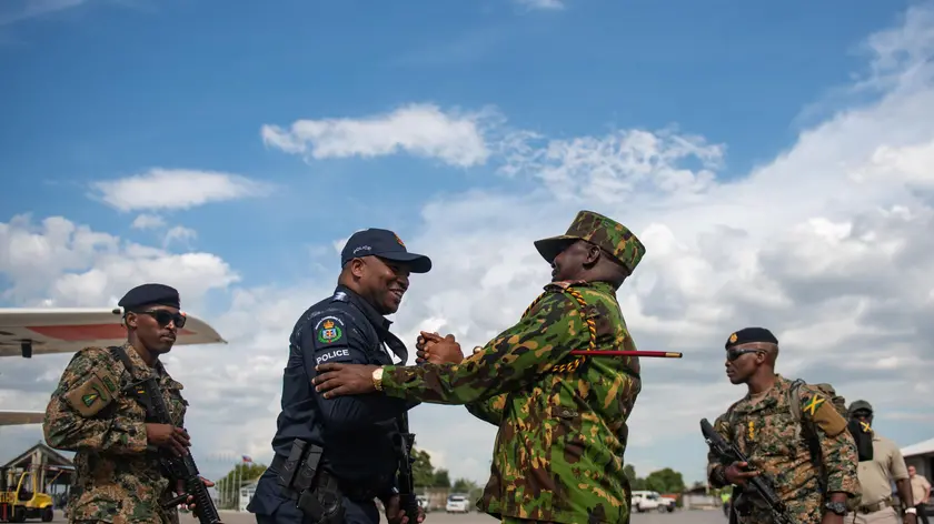 epa11601123 Kenyan Police Commander Godfrey Otunge (2-R) greets a policeman upon his arrival at Toussaint Louverture International Airport in Port-au-Prince, Haiti, 12 September 2024. The first Jamaican and Belizean troops for the Multinational Security Support Mission have arrived in Port-au-Prince and will join the 400 Kenyan agents, the country leading the operation, who are already in Haiti. EPA/Johnson Sabin