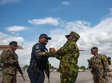 epa11601123 Kenyan Police Commander Godfrey Otunge (2-R) greets a policeman upon his arrival at Toussaint Louverture International Airport in Port-au-Prince, Haiti, 12 September 2024. The first Jamaican and Belizean troops for the Multinational Security Support Mission have arrived in Port-au-Prince and will join the 400 Kenyan agents, the country leading the operation, who are already in Haiti. EPA/Johnson Sabin