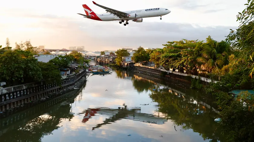 epa11174636 A Qantas Air Lines plane lands at Manila’s international airport, Philippines, 23 February 2024. Manila’s international airport, routinely ranked as one of the world's worst airports, will be upgraded and operated by top bidder San Miguel Corporation (SMC). The Philippine government awarded a three billion U.S. dollar contract for 15 years to SMC consortium owned by billionaire Ramon Ang. EPA/FRANCIS R. MALASIG