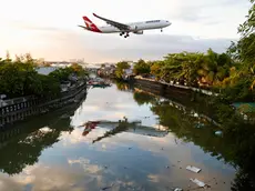 epa11174636 A Qantas Air Lines plane lands at Manila’s international airport, Philippines, 23 February 2024. Manila’s international airport, routinely ranked as one of the world's worst airports, will be upgraded and operated by top bidder San Miguel Corporation (SMC). The Philippine government awarded a three billion U.S. dollar contract for 15 years to SMC consortium owned by billionaire Ramon Ang. EPA/FRANCIS R. MALASIG