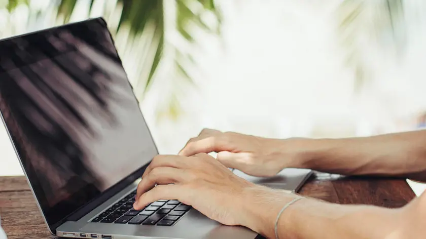 Caucasian man using laptop outdoors