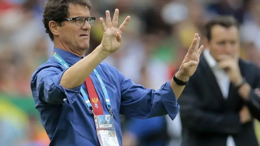 Russia's head coach Fabio Capello, left, gestures as he stands near Belgium's head coach Marc Wilmots, right, on the touchline during the group H World Cup soccer match between Belgium and Russia at the Maracana stadium in Rio de Janeiro, Brazil, Sunday, June 22, 2014. (AP Photo/Ivan Sekretarev)