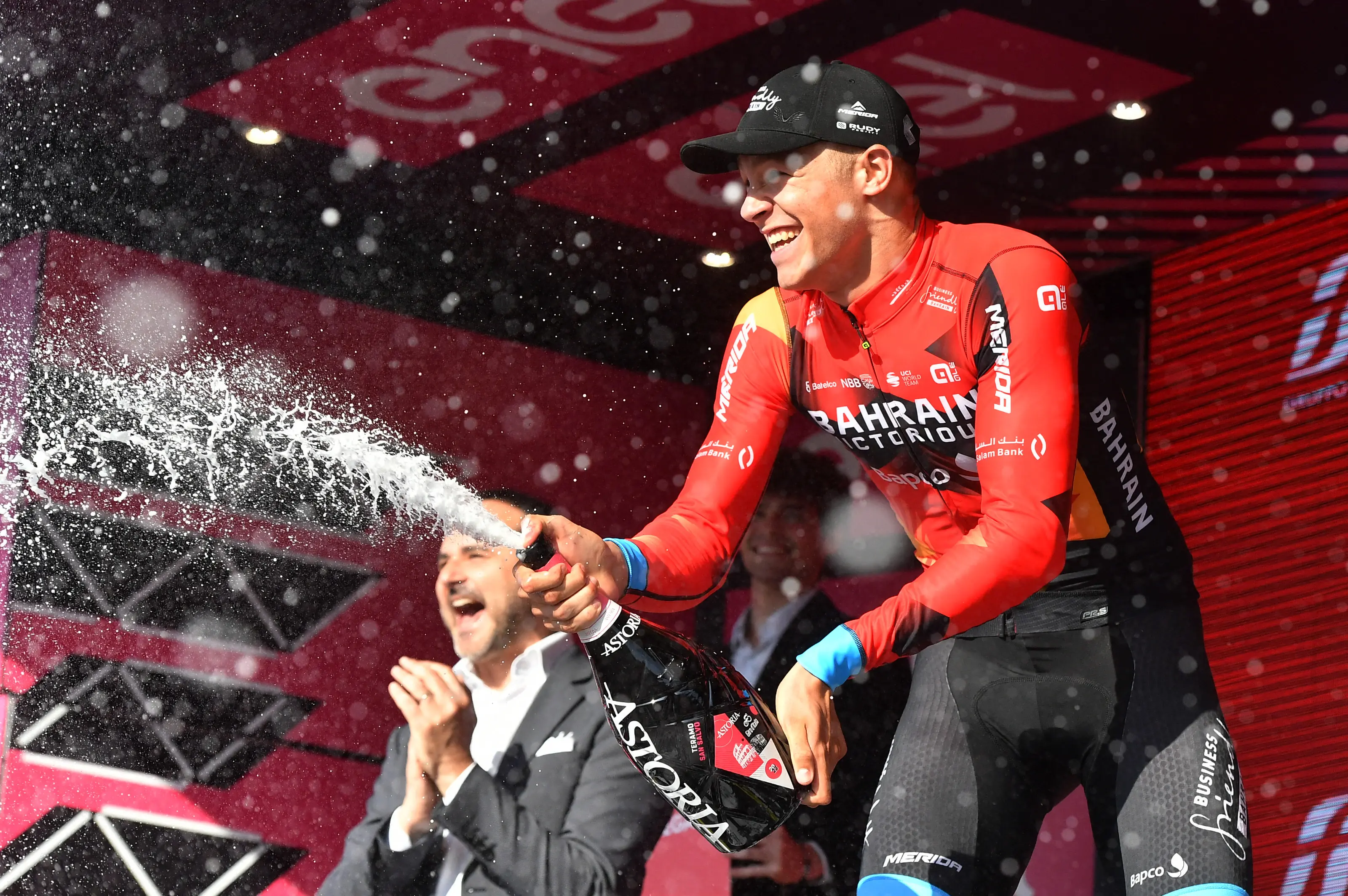 Cycling - Giro d'Italia - Stage 2 - Teramo to San Salvo - Italy - May 7, 2023 Bahrain – Victorious' Jonathan Milan sprays champagne to celebrate winning stage 2 REUTERS/Jennifer Lorenzini