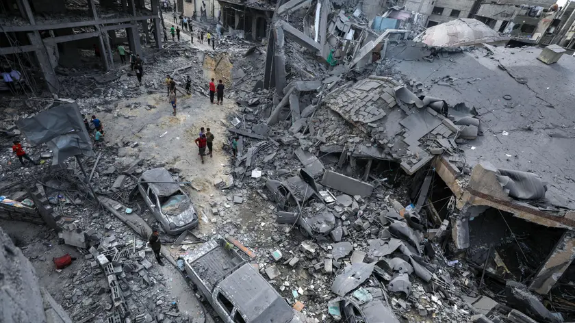 epa10909319 Palestinians walk amid the rubble of a destroyed area after Israeli air strikes in Gaza City, 09 October 2023. The Israeli army announced on 09 October, it carried out over 500 strikes on targets across the Gaza Strip overnight. Palestinian officials said almost 500 people were killed and over 2,700 were injured after Israel launched retaliatory raids and air strikes. An unprecedented attack on southern Israel on 07 October claimed by the Islamist movement Hamas killed more than 700 Israelis and left over 2,150 injured, the Israeli army said. EPA/MOHAMMED SABER