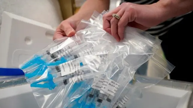 Syringes filled with Johnson & Johnson COVID-19 vaccine are loaded into a cooler in the pharmacy of National Jewish Hospital for distribution early Saturday, March 6, 2021, in east Denver. Volunteers worked with nurses and physicians from National Jewish to administer 2,500 vaccinations of the Johnson & Johnson vaccine that requires a single shot instead of two like the other vaccines. (AP Photo/David Zalubowski)