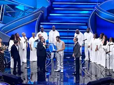 Italain singer Marco Mengoni receives a trophy for the best cover by Liguria Region President Giovanni Toti with Sanremo Festival host and artistic director Amadeus on stage at the Ariston theatre during the 73rd Sanremo Italian Song Festival, in Sanremo, Italy, 10 February 2023. The music festival will run from 07 to 11 February 2023. ANSA/RICCARDO ANTIMIANI