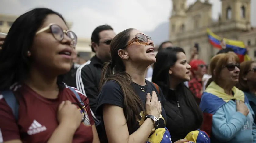 epaselect epa07339485 Venezuelan citizens rally to show support to President of the Venezuelan National Assembly Juan Guaido, at the Bolivar Square, in Bogota, Colombia, 02 February 2019. Meanwhile, Venezuela's President Nicolas Maduro and his opponent National Assembly leader Juan Guaido have called on their supporters to take to the streets in Venezuela as international pressure increased on Maduro to resign. Guiado had declared himself interim president of Venezuela on 23 January and promised to guide the country toward new election as he consider last May's election not valid. EPA/Juan Paez