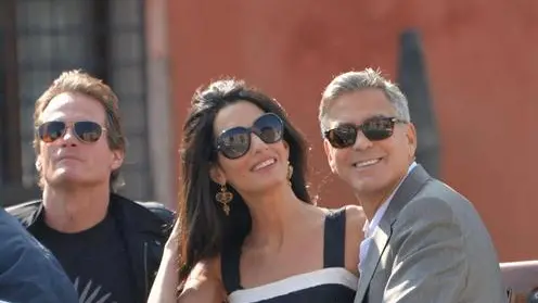 George Clooney and his girlfriend Amal Alamuddin stand on a taxi boat in Venice, 26 September 2014. The wedding civil ceremony is expected to take place in a 14th century palace, owned by the Venice council, almost in front of the Aman resort. ANSA/ANDREA MEROLA