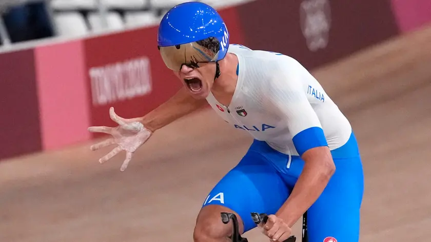 Jonathan Milan of Team Italy celebrates after winning the gold medal and setting a world record during the track cycling men's team pursuit at the 2020 Summer Olympics, Wednesday, Aug. 4, 2021, in Izu, Japan. (AP Photo/Christophe Ena)