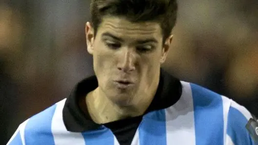 Racing Club's Rodrigo De Paul, left, vies for the ball with Maximiliano Velazquez of Lanus at a Copa Sudamericana soccer match in Buenos Aires, Argentina, Wednesday, Aug. 28, 2013. (AP Photo/Eduardo Di Baia)