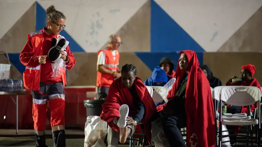 epa11281450 Some of a group of 52 migrants are assisted as they arrive to Gran Tarajal Port in Fuerteventura, Canary Islands, Spain, 16 April 2024. A total of 152 migrants have arrived during the last hours to Canary Islands coasts in Gran Canaria, Lanzarote and Fuerteventura. EPA/Carlos de Saa