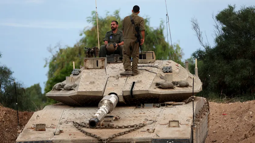 epa10948907 An Israeli military unit with a tank during maneuvers in the Western Galilee, as they guard along the border with Lebanon, northern Israel, 30 October 2023. Tensions remain high at the border between Israel and Lebanon after the Israeli-Palestinian conflict escalated following an unprecedented attack carried out by Hamas militants from Gaza into Israel on 07 October 2023. EPA/ATEF SAFADI