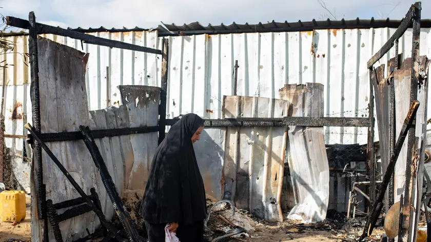 epa11421989 A Palestinian woman inspects their tents after an Israeli military strike at an area designated as a 'safe zone' for displaced people, between Khan Yunis and Rafah, southern Gaza Strip, 19 June 2024. At least 24 people were killed and over 70 others injured in the past 24 hours, the Palestinian Ministry of Health said on 19 June. More than 37,000 Palestinians and over 1,400 Israelis have been killed, according to the Palestinian Health Ministry and the Israel Defense Forces (IDF), since Hamas militants launched an attack against Israel from the Gaza Strip on 07 October 2023, and the Israeli operations in Gaza and the West Bank which followed it. EPA/HAITHAM IMAD