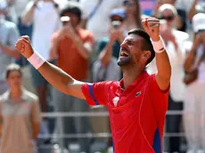 Novak Djokovic of Serbia cries as he celebrates after winning against Carlos Alcaraz of Spain in their Men Singles gold medal match of the Tennis competitions in the Paris 2024 Olympic Games, at the Roland Garros in Paris, France, 04 August 2024. ANSA/ETTORE FERRARI