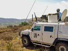 epa11566889 A soldier of the UN peacekeeping mission, United Nations Interim Force in Lebanon (UNIFIL), keeps watch from Marjayoun area opposite Lebanese Khiyam town and Israeli Metula settlement, near the Lebanon-Israel border in southern Lebanon, 27 August 2024. Hezbollah announced in a statement on 25 August that the group launched an aerial operation with numerous drones targeting Israeli territory as the 'phase one' of a retaliatory attack for the killing of senior Hezbollah commander Fuad Shukr on 30 July in Beirut. The Israeli Defense Forces (IDF) said some 100 fighter jets struck and destroyed thousands of Hezbollah rocket launcher barrels, aimed for immediate fire toward northern and central Israel. EPA/STR