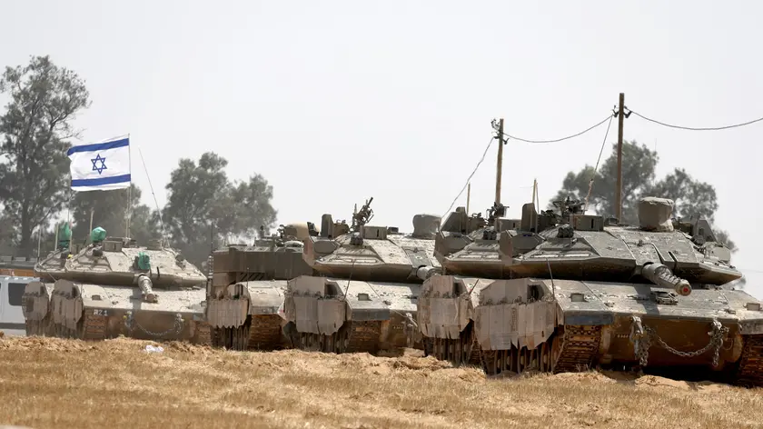 epa11312278 Israeli soldiers with military vehicles gather at a position on the southern Israeli border with the Gaza Strip, near the Palestinian city of Rafah, 01 May 2024. More than 34,300 Palestinians and over 1,455 Israelis have been killed, according to the Palestinian Health Ministry and the Israel Defense Forces (IDF), since Hamas militants launched an attack against Israel from the Gaza Strip on 07 October 2023, and the Israeli operations in Gaza and the West Bank which followed it. EPA/ATEF SAFADI