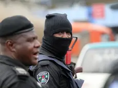 epa09534457 A policeman is seen wearing a hood during a memorial protest for a military attack at the Lekki tollgate in Lagos, Nigeria, 20 October 2021. Police disperse youths who held a memorial protest in Lagos to commemorate a military attack during the protest against police brutality on 20 October 2020. EPA/AKINTUNDE AKINLEYE