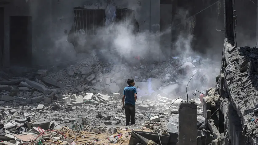 epaselect epa11419582 A Palestinian boy inspects the damage following an Israeli air strike at al-Bureij refugee camp, southern Gaza Strip, 18 June 2024. More than 37,000 Palestinians and over 1,400 Israelis have been killed, according to the Palestinian Health Ministry and the Israel Defense Forces (IDF), since Hamas militants launched an attack against Israel from the Gaza Strip on 07 October 2023, and the Israeli operations in Gaza and the West Bank which followed it. EPA/MOHAMMED SABER