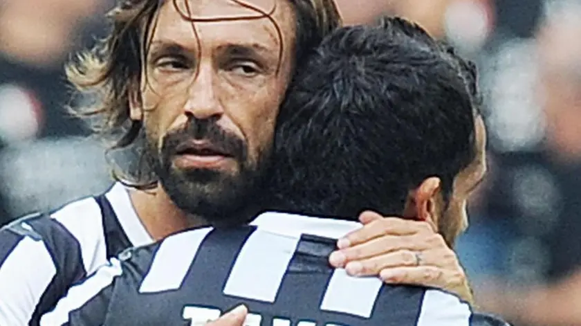 Argentinian forward of Fc Juventus Carlos Tevez celebrates with Andrea Pirlo (R) after scoring the 1-1 against Hella Verona during Italian Serie A soccer match at the Juventus Stadium, Turin, 22 September 2013. ANSA/ALESSANDRO DI MARCO