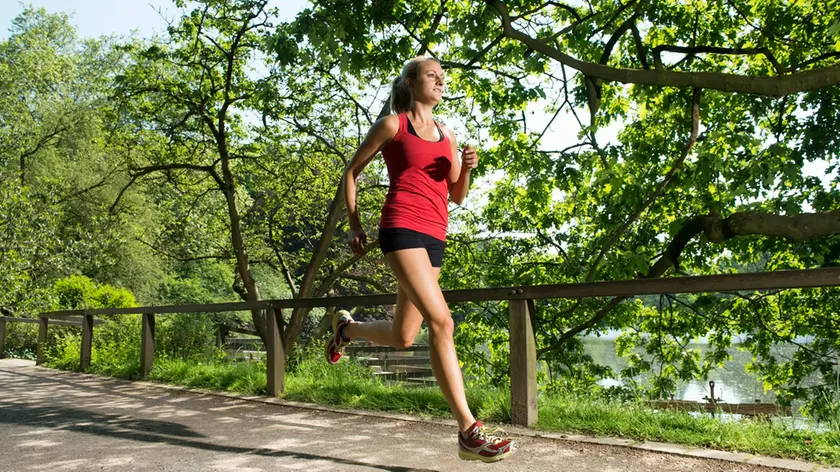 24 May 2012 --- Young woman running --- Image by © Jens Nieth/Corbis