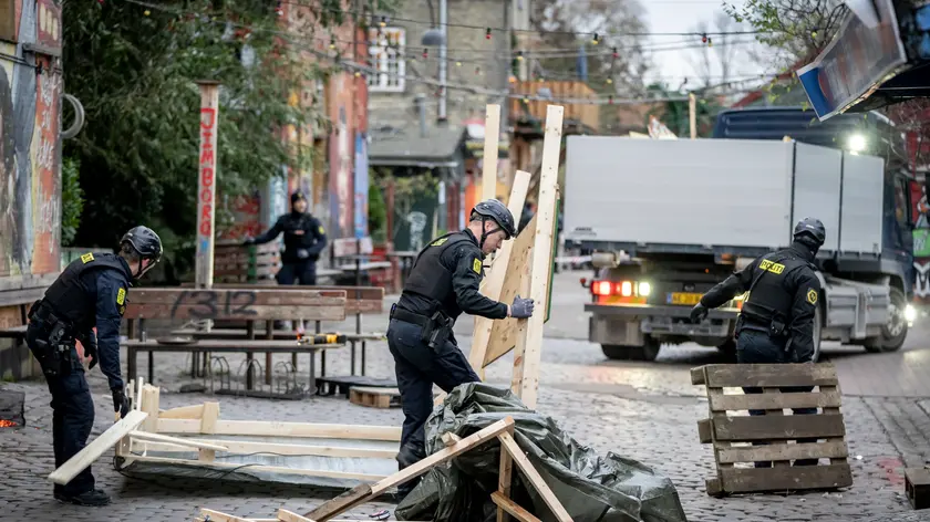 epa10989973 Members of the Copenhagen Police clear Pusher Street in the Freetown Christiania for temporary closure in Copenhagen, Denmark, 22 November 2023. The ongoing work will eventually lead to a permanent closure of the area notorious for drug trafficking and gang crime, as announced by the Danish Minister of Justice in September 2023. EPA/Mads Claus Rasmussen DENMARK OUT
