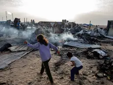 epa11372895 Palestinians inspect the damage after an Israeli army raid on a camp at an area designated for displaced people in Rafah, southern Gaza Strip, 27 May 2024. At least 40 people were killed after Israeli airstrikes hit an area in Rafah designated for the displaced, the Palestinian Civil Defense said. More than 35,000 Palestinians and over 1,400 Israelis have been killed, according to the Palestinian Health Ministry and the Israel Defense Forces (IDF), since Hamas militants launched an attack against Israel from the Gaza Strip on 07 October 2023, and the Israeli operations in Gaza and the West Bank which followed it. EPA/HAITHAM IMAD