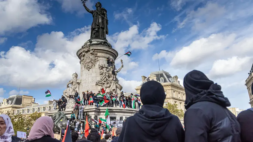 epa10932989 Protesters hold Palestinian flags during a demonstration to support Palestine, at the Place de la Republique in Paris, France, 22 October 2023. Thousands of Israelis and Palestinians have died since the militant group Hamas launched an unprecedented attack on Israel from the Gaza Strip on 07 October, and the Israeli strikes on the Palestinian enclave which followed it. EPA/CHRISTOPHE PETIT TESSON